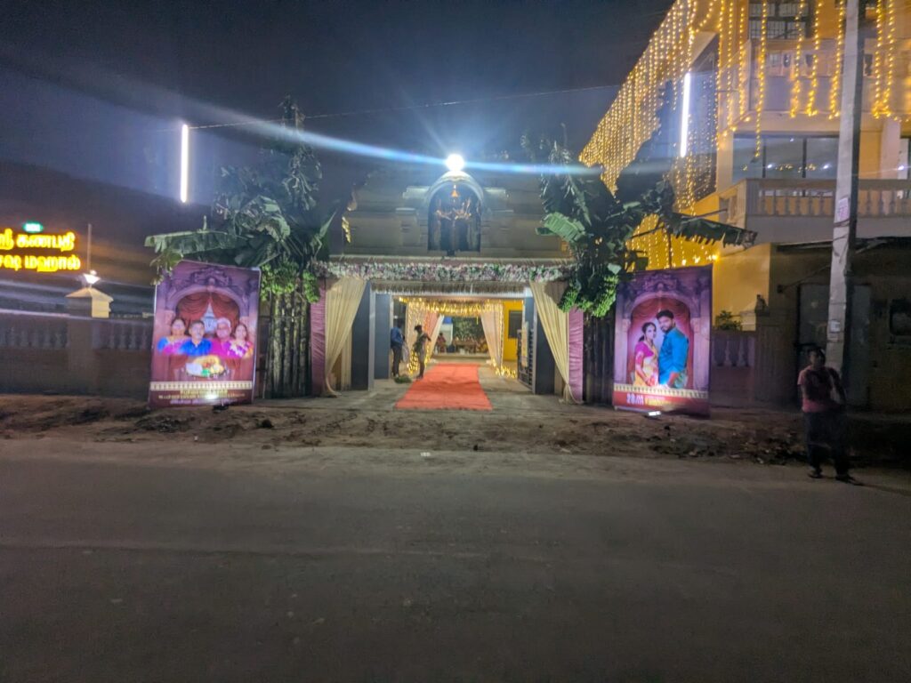 Wedding entrance canopy with warm LED curtain lights and red carpet at K C M Mahal Auroville Pondicherry