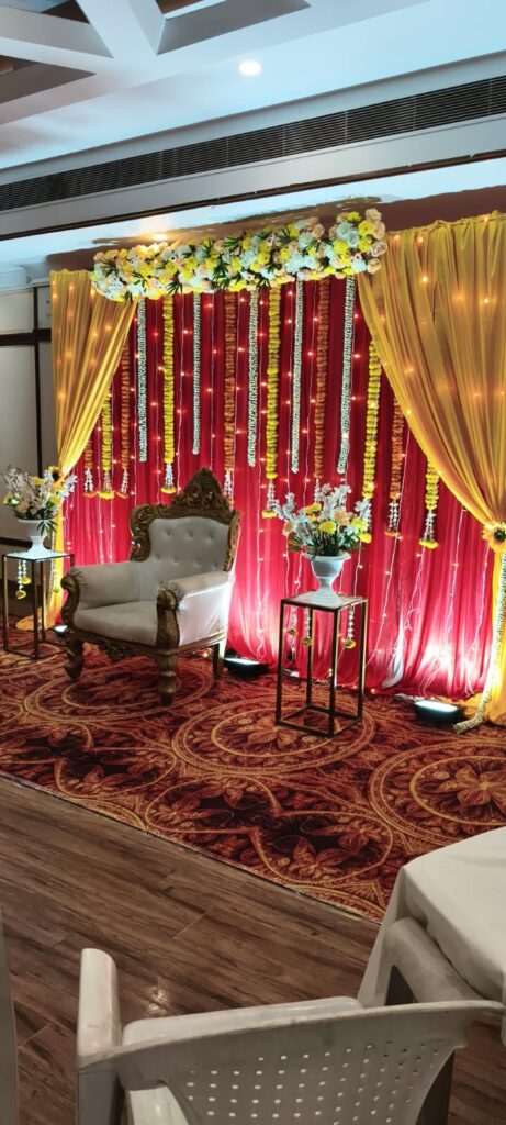 Mehendi ceremony backdrop with marigold garlands and LED lights